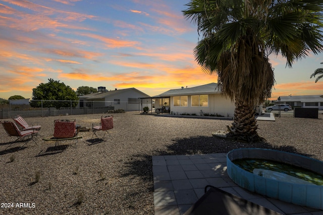 yard at dusk with a patio area