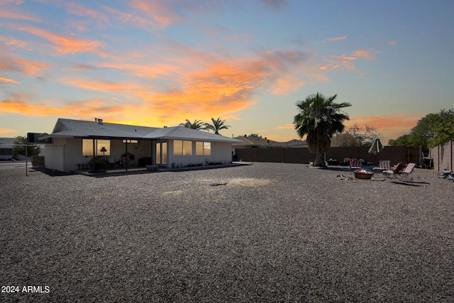 back house at dusk with a patio