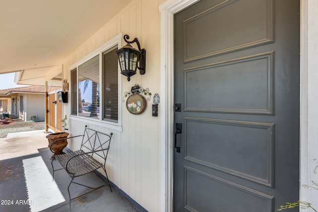 view of exterior entry featuring covered porch