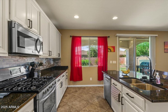 3936 E Narrowleaf Dr, Gilbert, AZ 85298 - kitchen featuring stainless steel appliances, a sink, white cabinets, backsplash, and baseboards