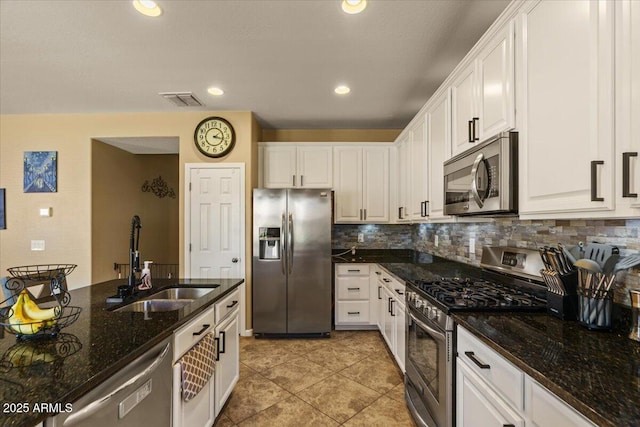 3936 E Narrowleaf Dr, Gilbert, AZ 85298 - kitchen featuring stainless steel appliances, a sink, white cabinetry, decorative backsplash, and light tile patterned floors