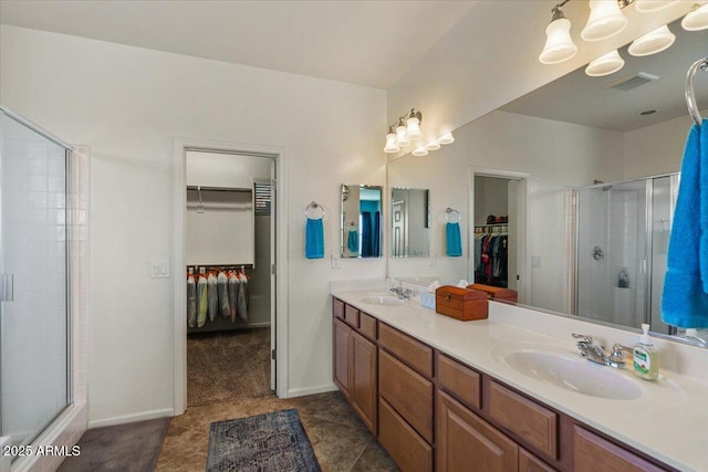 3936 E Narrowleaf Dr, Gilbert, AZ 85298 - full bath featuring a walk in closet, double vanity, a shower stall, tile patterned floors, and baseboards