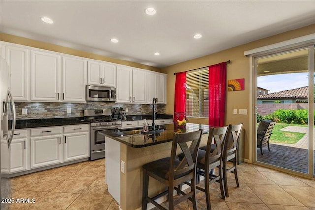3936 E Narrowleaf Dr, Gilbert, AZ 85298 - kitchen featuring appliances with stainless steel finishes, plenty of natural light, white cabinetry, and recessed lighting