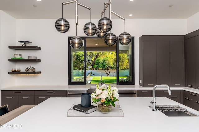 kitchen with dishwasher, hanging light fixtures, sink, and dark brown cabinets