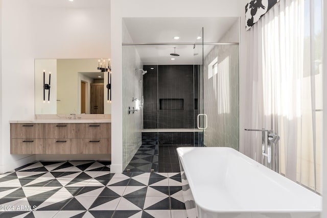 bathroom featuring vanity and shower with separate bathtub