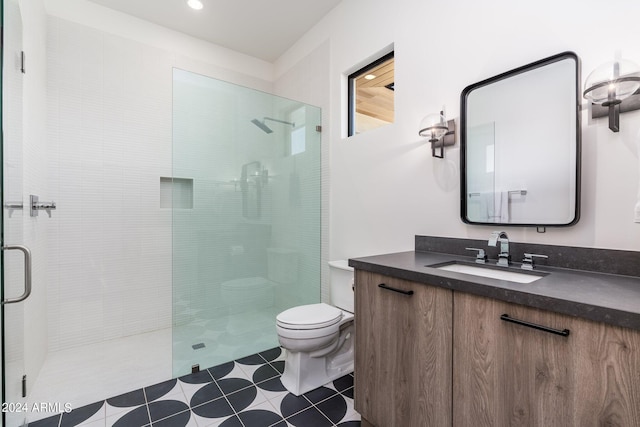 bathroom featuring an enclosed shower, vanity, tile patterned flooring, and toilet