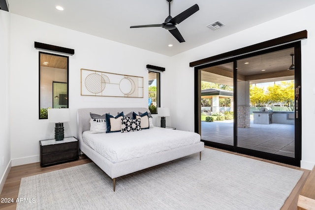 bedroom featuring access to outside, wood-type flooring, and ceiling fan