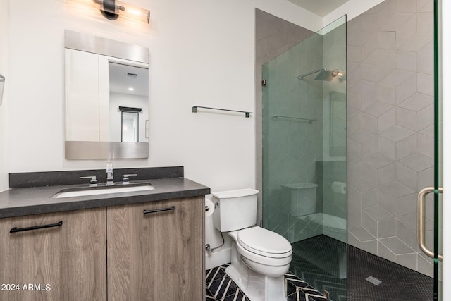 bathroom featuring vanity, a shower with shower door, and toilet