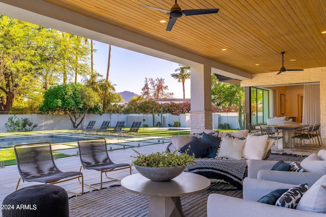 view of patio with outdoor lounge area and ceiling fan