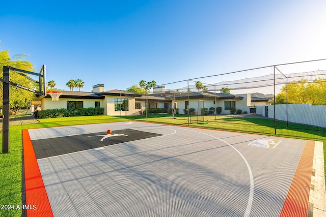 view of sport court featuring a lawn