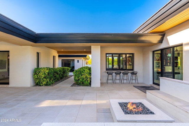 doorway to property featuring an outdoor bar and a patio