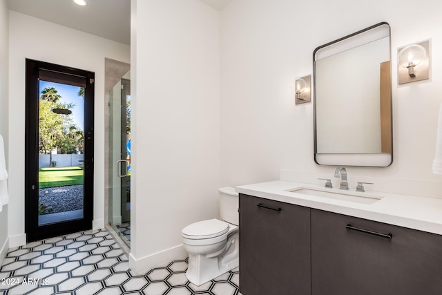 bathroom with walk in shower, vanity, and toilet