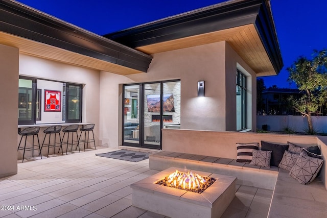 exterior space featuring a fire pit and a bar