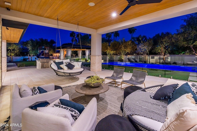 patio at twilight with an outdoor hangout area and ceiling fan