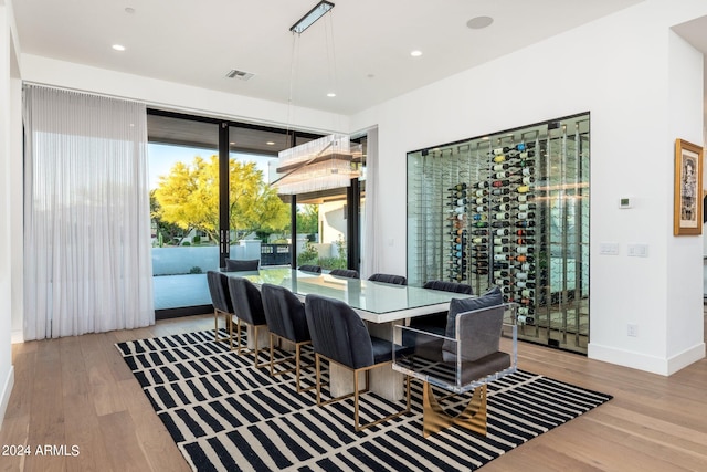 wine cellar with light hardwood / wood-style floors