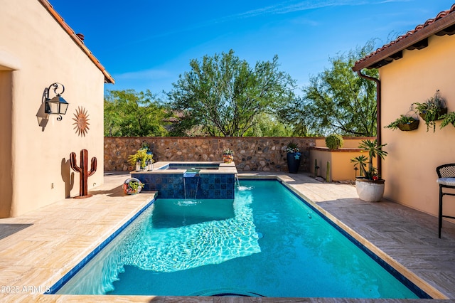 view of pool featuring a fenced in pool, fence, an in ground hot tub, and a patio area