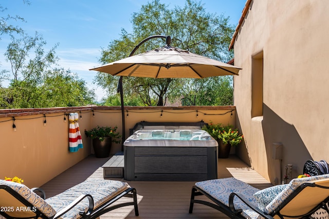 view of patio with a deck and a hot tub