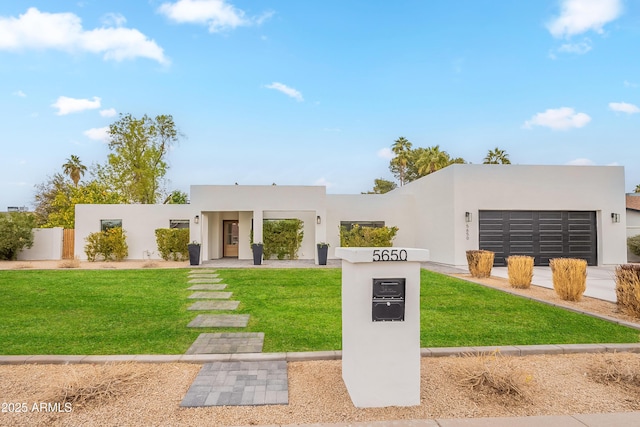 view of front of property featuring a front yard and a garage