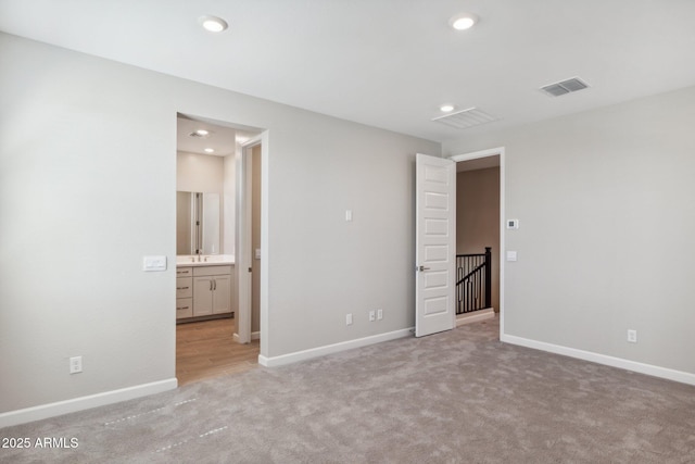 unfurnished bedroom with recessed lighting, visible vents, light colored carpet, and baseboards