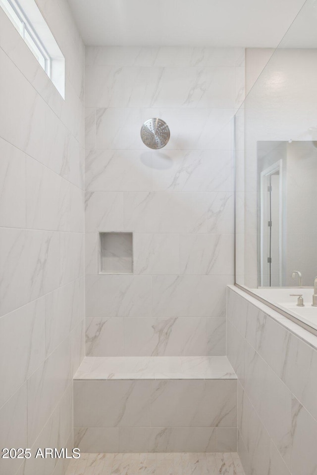 full bathroom with a tile shower