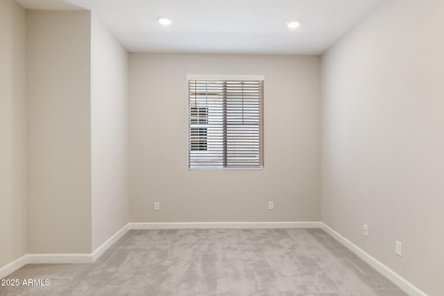 spare room featuring recessed lighting, baseboards, and light carpet