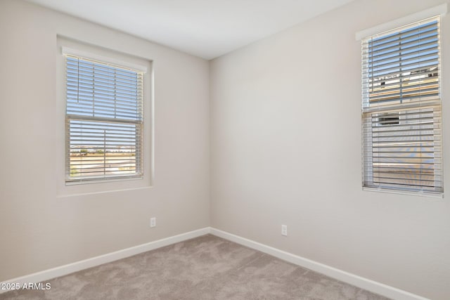 carpeted empty room with baseboards