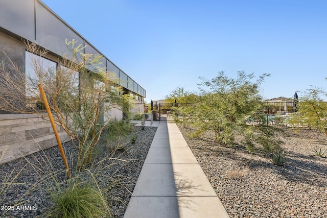 view of home's community featuring fence