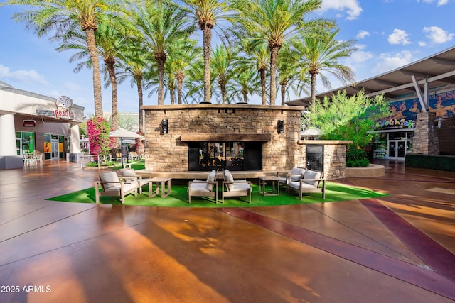 view of patio with an outdoor living space with a fireplace