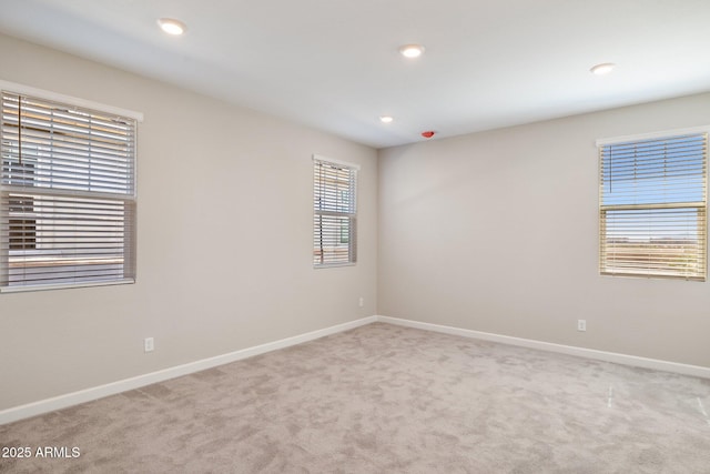 carpeted spare room featuring recessed lighting and baseboards