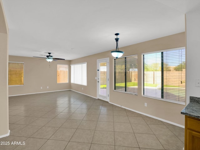 13620 N 82nd Ln, Peoria, AZ 85381 - unfurnished living room with baseboards, light tile patterned flooring, and a ceiling fan