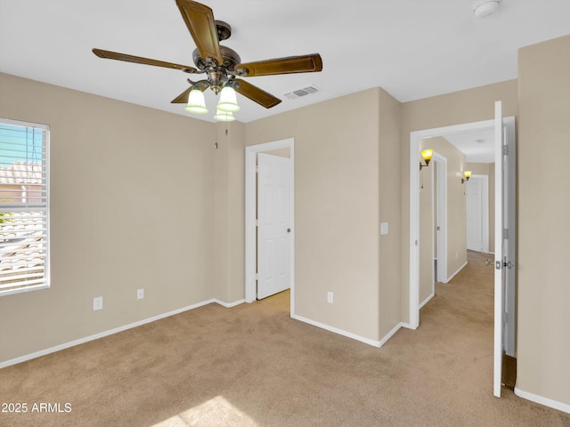 13620 N 82nd Ln, Peoria, AZ 85381 - unfurnished bedroom featuring light colored carpet, baseboards, and a ceiling fan
