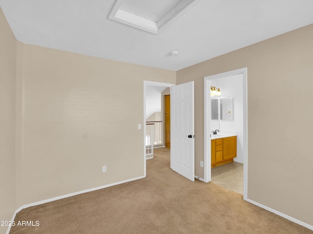 13620 N 82nd Ln, Peoria, AZ 85381 - unfurnished bedroom featuring light carpet, baseboards, a sink, and ensuite bathroom