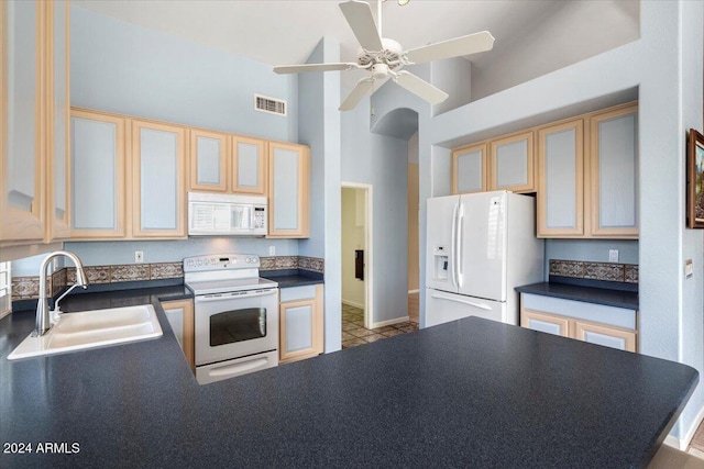 kitchen featuring ceiling fan, white appliances, high vaulted ceiling, and sink