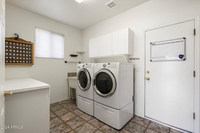 laundry room with cabinets and washing machine and clothes dryer