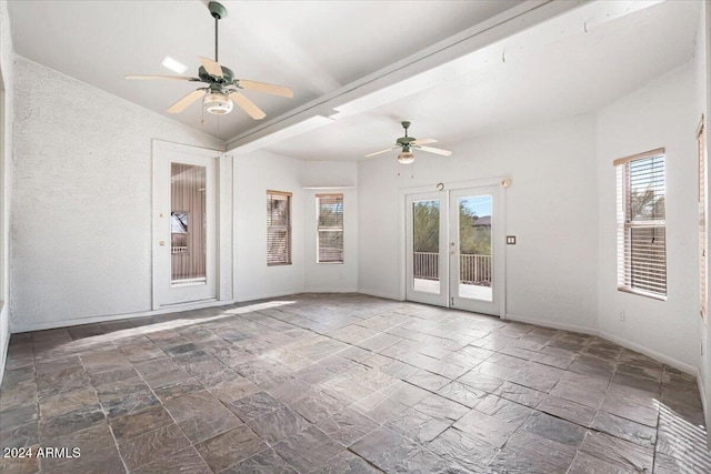 empty room featuring ceiling fan and lofted ceiling