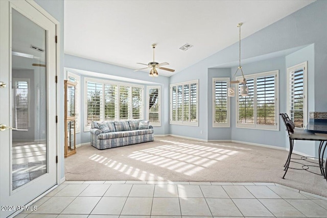 unfurnished sunroom with ceiling fan, plenty of natural light, and vaulted ceiling