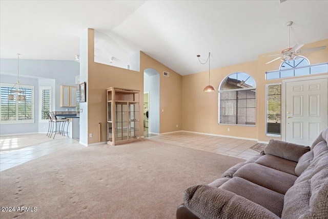 carpeted living room featuring high vaulted ceiling and ceiling fan