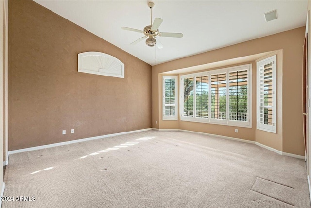 carpeted empty room with lofted ceiling and ceiling fan