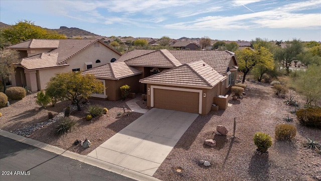 view of front facade featuring a garage and a mountain view