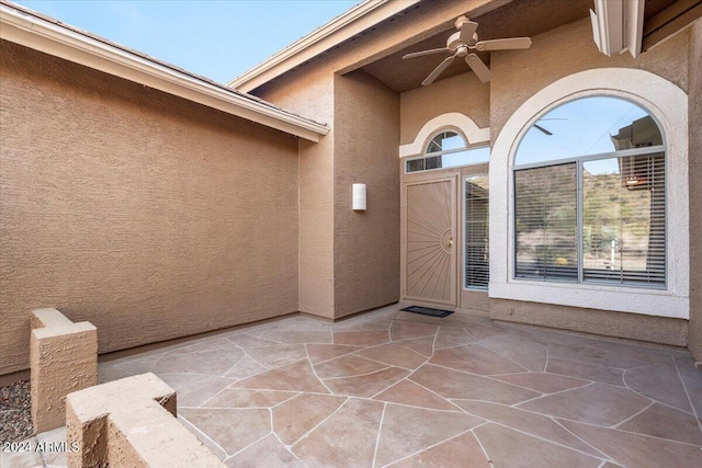 doorway to property with a patio area and ceiling fan