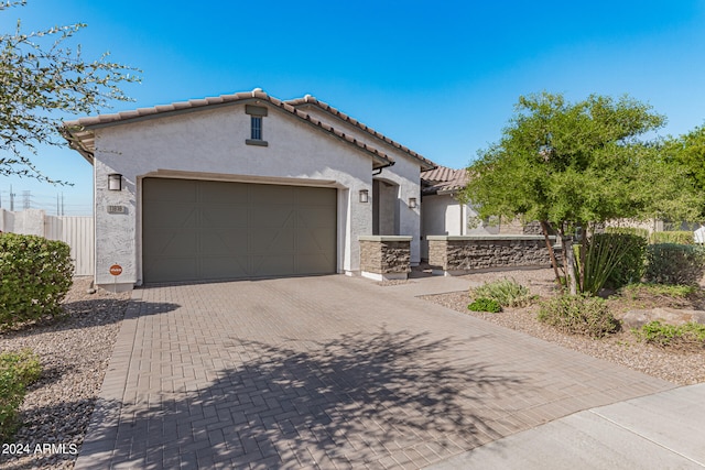 mediterranean / spanish-style home featuring a garage