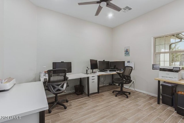 home office with ceiling fan and light hardwood / wood-style flooring