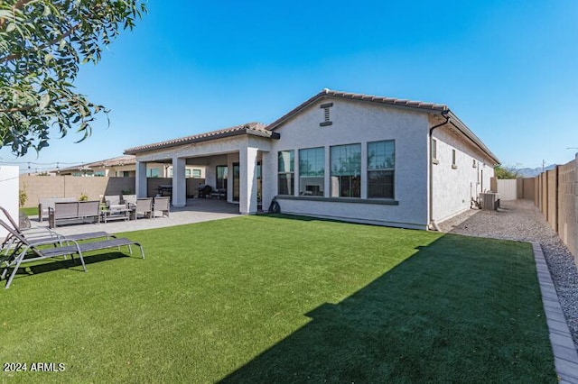 back of house featuring an outdoor hangout area, central air condition unit, a patio area, and a lawn