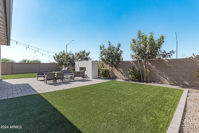 view of yard featuring a tiled fireplace and a patio area