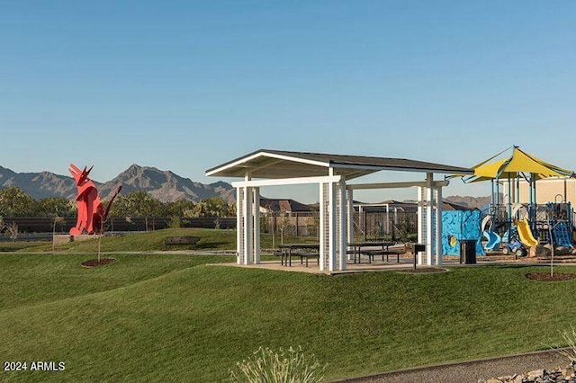 exterior space featuring a mountain view and a yard