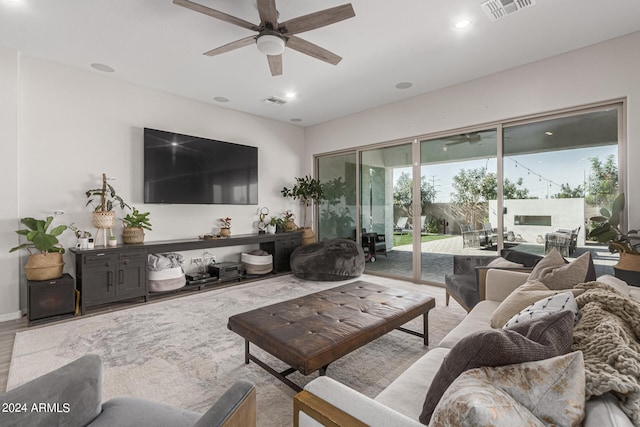 living room featuring light hardwood / wood-style floors and ceiling fan