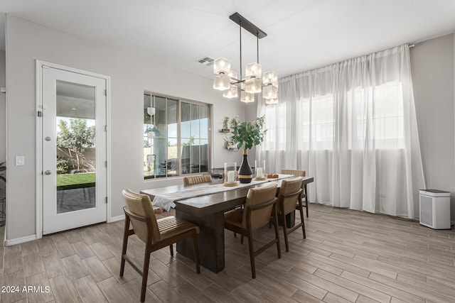 dining room with a wealth of natural light and a notable chandelier