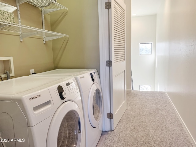 laundry area featuring carpet flooring, baseboards, laundry area, and washing machine and clothes dryer