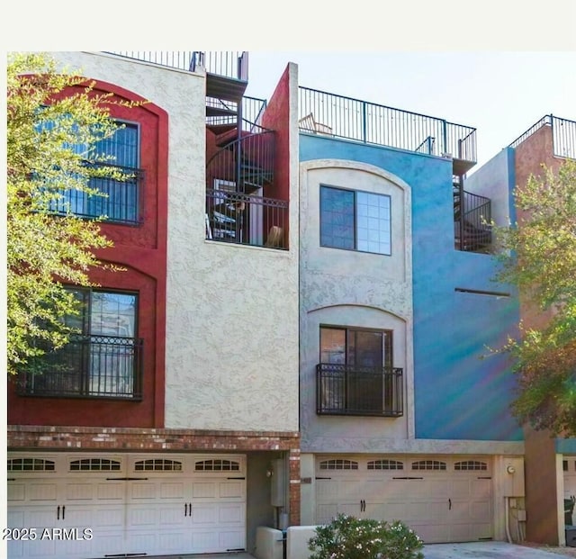 view of front of property with a garage and stucco siding