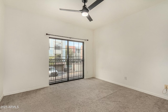 carpeted spare room with baseboards and ceiling fan